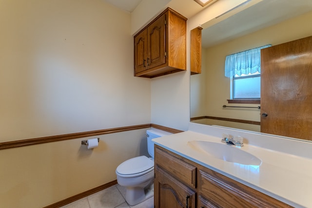 bathroom featuring tile patterned floors, vanity, and toilet