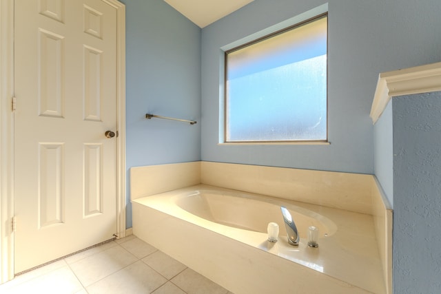 bathroom featuring tile patterned floors and a bathtub