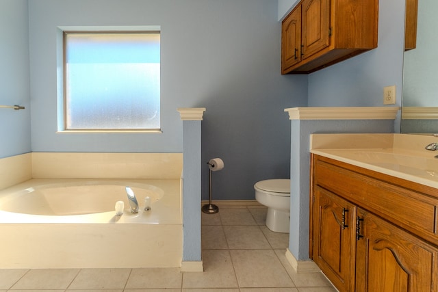 bathroom featuring tile patterned flooring, vanity, toilet, and a bath