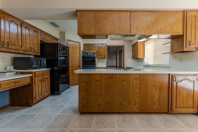 kitchen featuring black appliances, kitchen peninsula, and sink