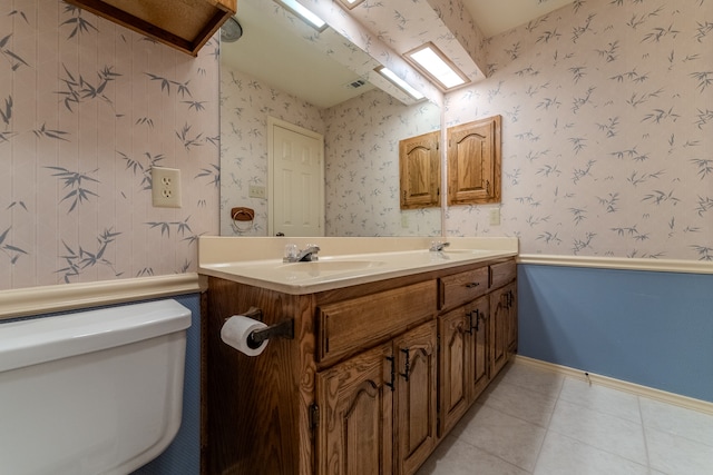 bathroom featuring tile patterned floors, vanity, and toilet