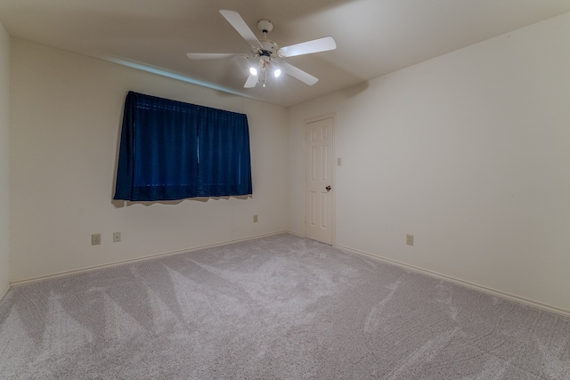 carpeted empty room featuring ceiling fan