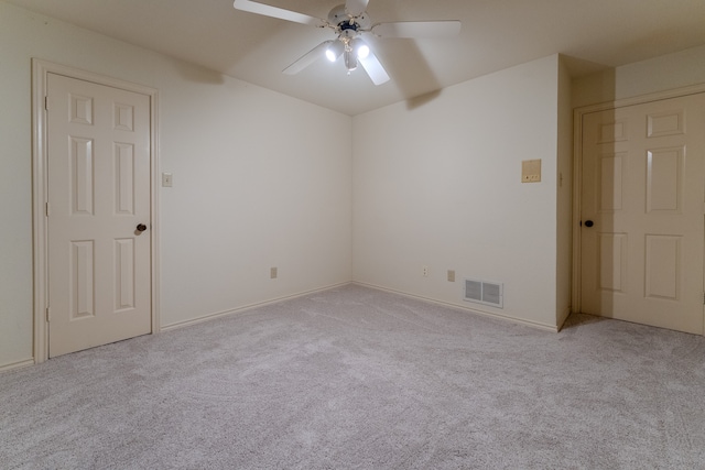 spare room featuring ceiling fan and light colored carpet