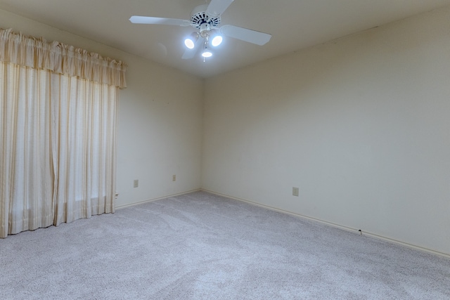 unfurnished room featuring ceiling fan and light carpet