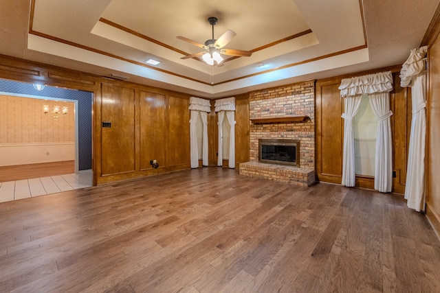 unfurnished living room featuring a raised ceiling and hardwood / wood-style floors