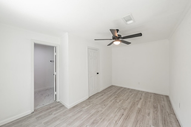 spare room featuring light wood-type flooring and ceiling fan