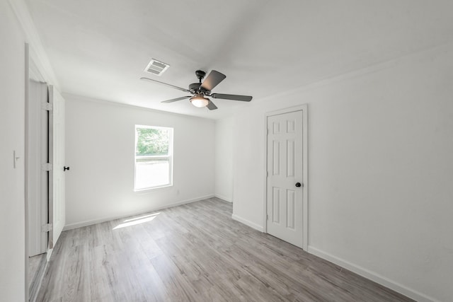 unfurnished room featuring ceiling fan, light hardwood / wood-style flooring, and ornamental molding