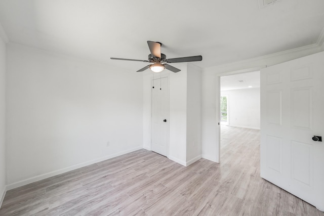 empty room featuring light hardwood / wood-style flooring, ceiling fan, and crown molding