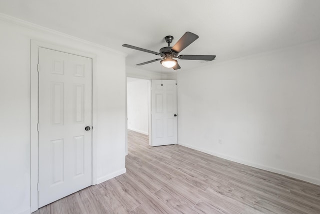 spare room featuring ornamental molding, light wood-type flooring, and ceiling fan