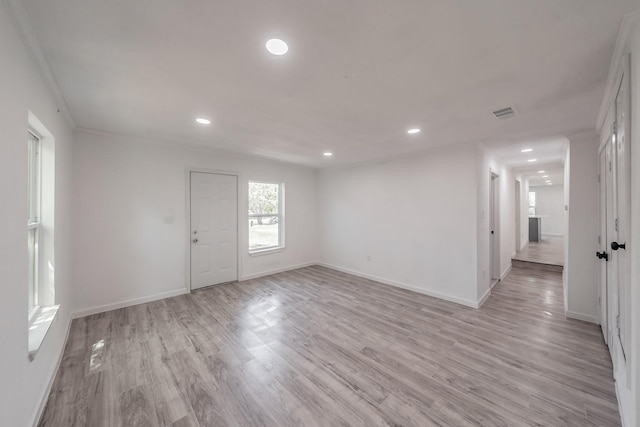 interior space featuring light hardwood / wood-style floors and crown molding