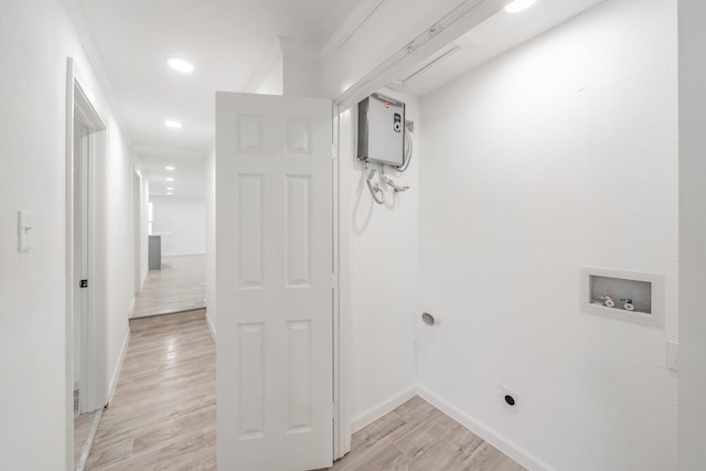 clothes washing area with washer hookup, crown molding, electric dryer hookup, and light hardwood / wood-style floors