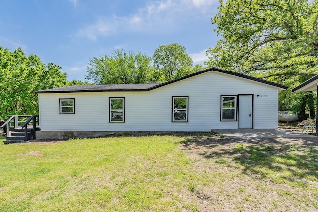 back of property featuring a yard