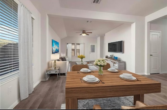 dining space with lofted ceiling, ceiling fan, and hardwood / wood-style floors