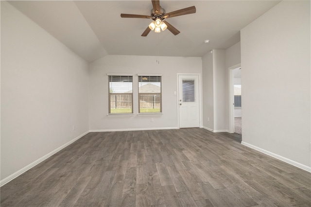 empty room featuring dark hardwood / wood-style flooring, lofted ceiling, and ceiling fan