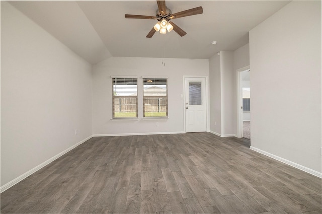 spare room featuring vaulted ceiling, ceiling fan, and dark hardwood / wood-style floors