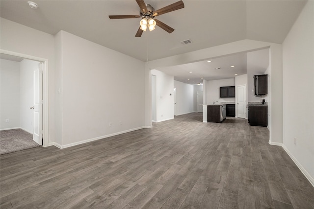 unfurnished living room with dark wood-type flooring and ceiling fan