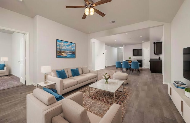 living room featuring ceiling fan, lofted ceiling, and dark hardwood / wood-style flooring