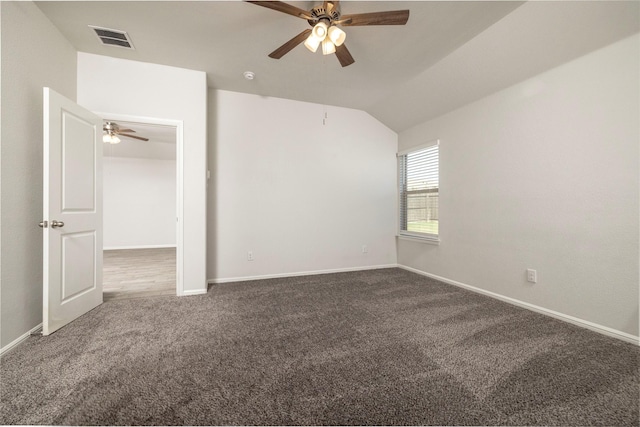 empty room featuring ceiling fan, carpet floors, and lofted ceiling