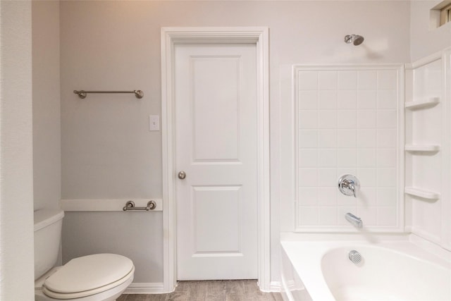 bathroom with wood-type flooring, toilet, and  shower combination