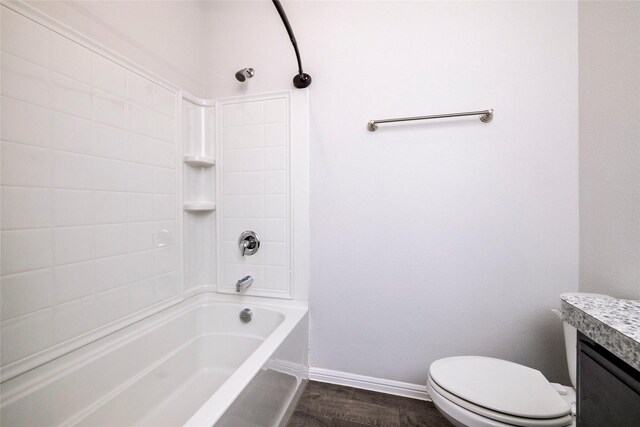 full bathroom featuring toilet, vanity, wood-type flooring, and tiled shower / bath