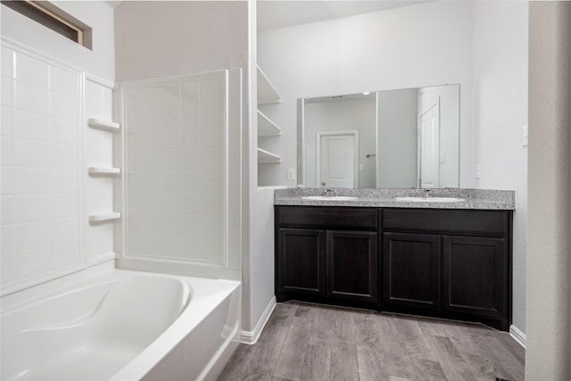 bathroom with hardwood / wood-style floors, shower / washtub combination, and vanity