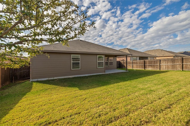 back of house with a patio and a yard