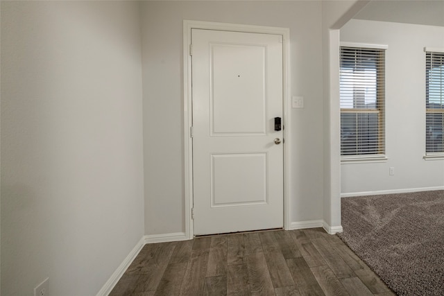 doorway with dark wood-type flooring