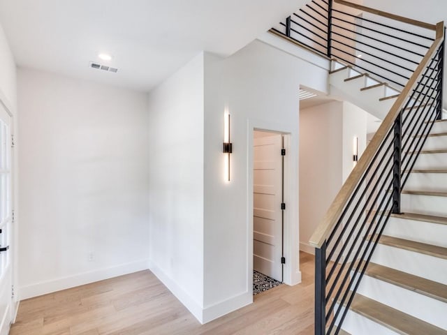 stairway featuring hardwood / wood-style flooring