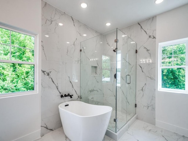 bathroom featuring separate shower and tub