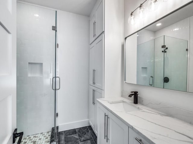 bathroom with tile patterned flooring, vanity, and a shower with shower door