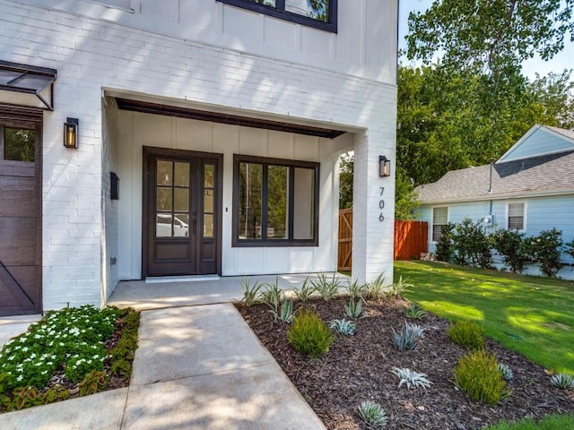 entrance to property with a lawn