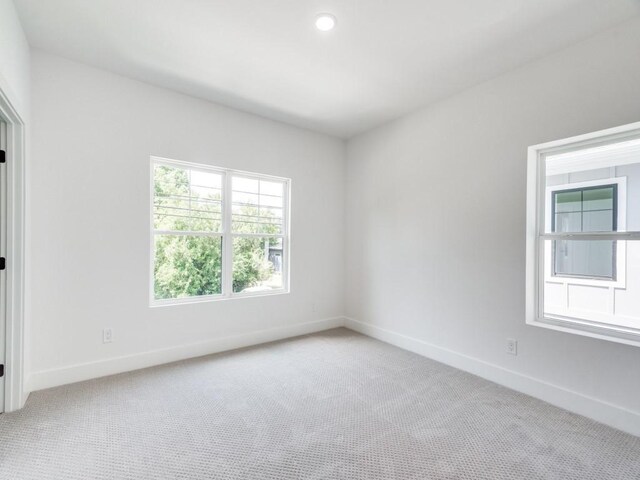 unfurnished room with light colored carpet