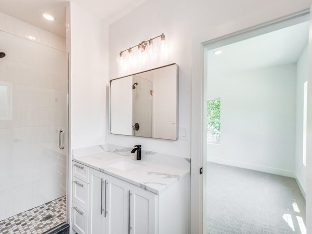 bathroom featuring vanity and a shower with shower door