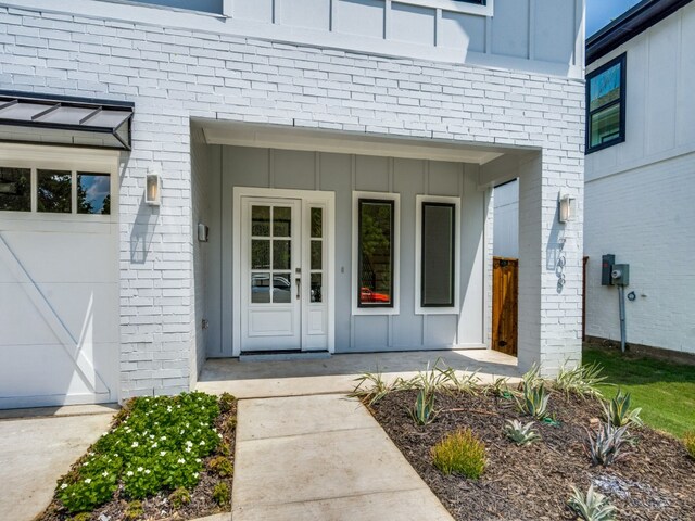 doorway to property with a garage