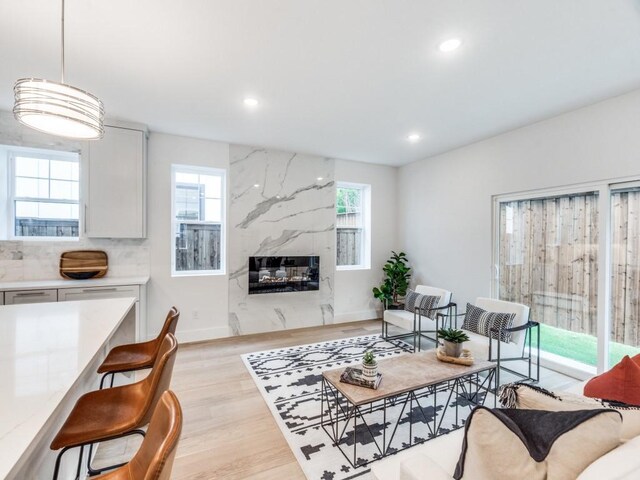 living room featuring light hardwood / wood-style floors, sink, and a chandelier