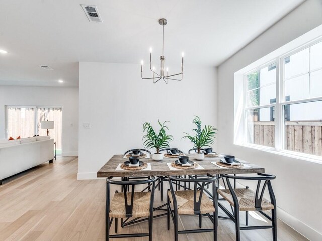 living room with light hardwood / wood-style floors and a high end fireplace