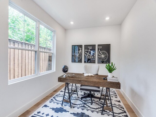 dining area with light wood-type flooring and a chandelier