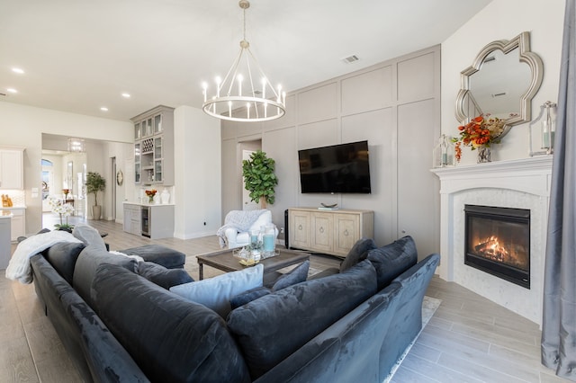 living room featuring light wood-type flooring and an inviting chandelier