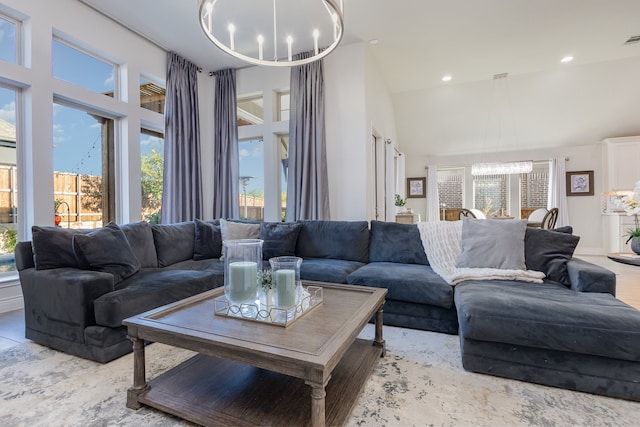 living room with high vaulted ceiling and a chandelier