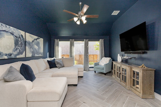 living room with ceiling fan, light parquet floors, and vaulted ceiling