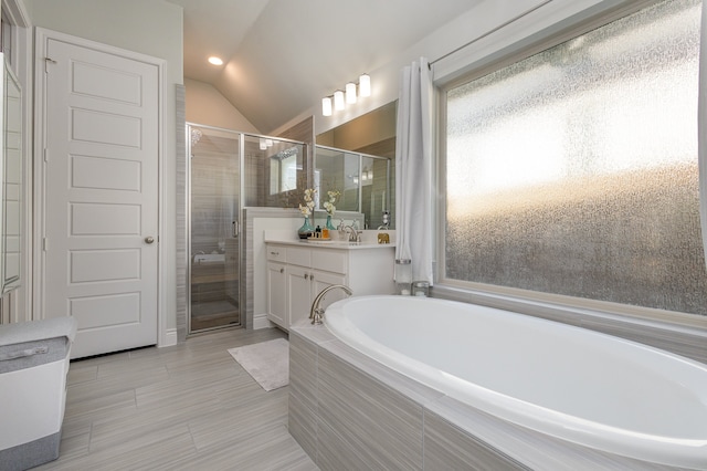 bathroom with shower with separate bathtub, vanity, and lofted ceiling