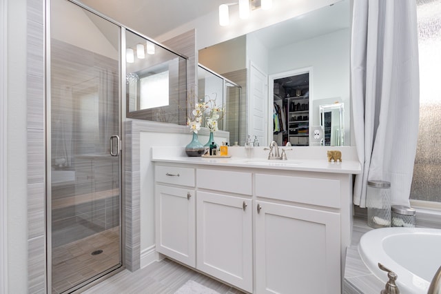 bathroom with vanity, wood-type flooring, and plus walk in shower