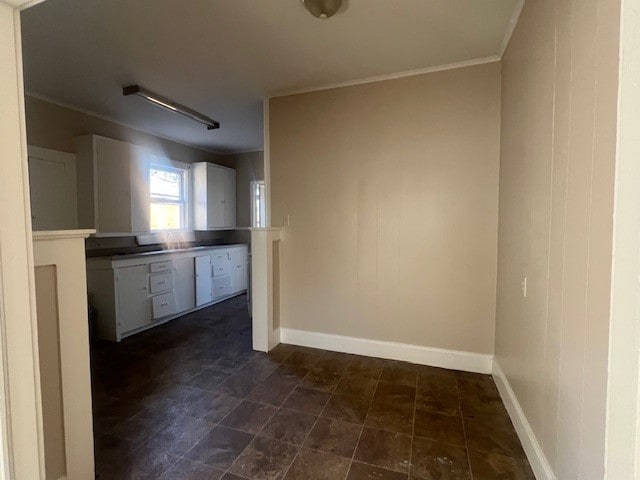 kitchen with white cabinetry and crown molding