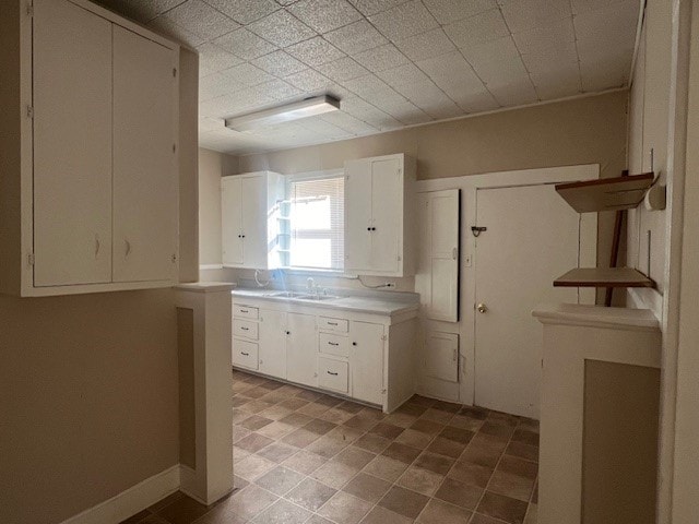 kitchen featuring sink and white cabinets