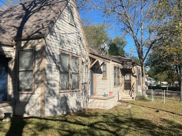 view of side of home with a lawn