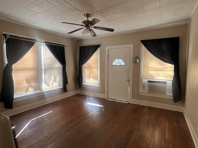 entrance foyer with ceiling fan, a healthy amount of sunlight, and dark hardwood / wood-style flooring