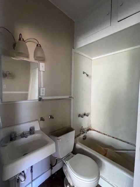 full bathroom featuring sink, tub / shower combination, and toilet