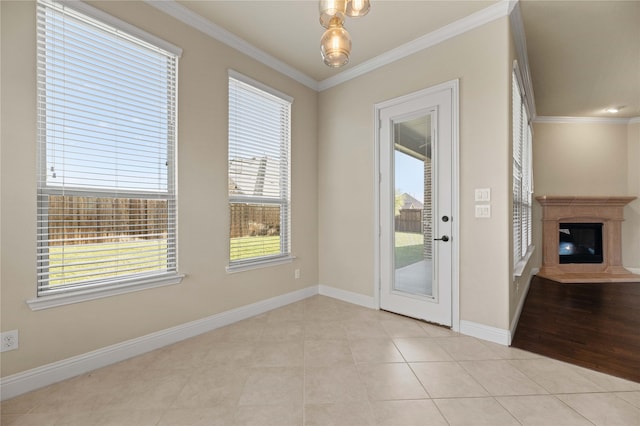 doorway to outside featuring light tile patterned flooring and ornamental molding