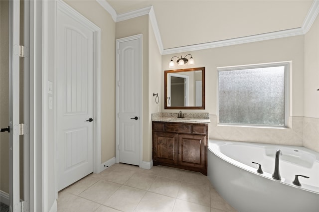 bathroom featuring tile patterned floors, vanity, a tub, and crown molding