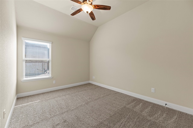 carpeted empty room with ceiling fan and lofted ceiling